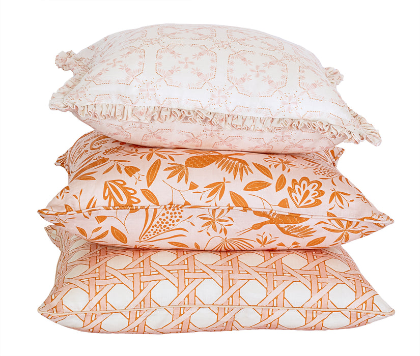 Garden Linen Fabric in Pink Sunshine shown in a stack of decorative pillows