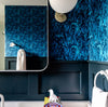 Ocean Seaweed wallpaper in Prussian Blue installed in a bathroom with dark blue wainscoting