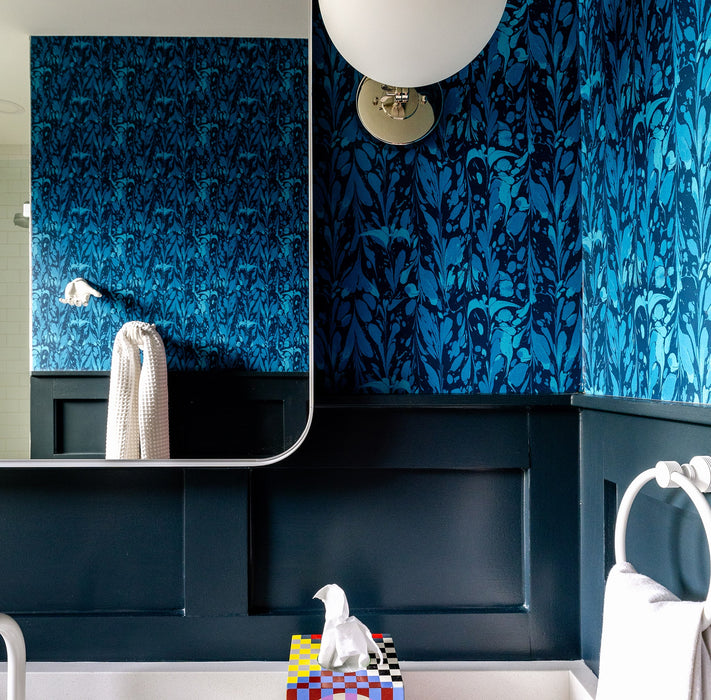 Ocean Seaweed wallpaper in Prussian Blue installed in a bathroom with dark blue wainscoting