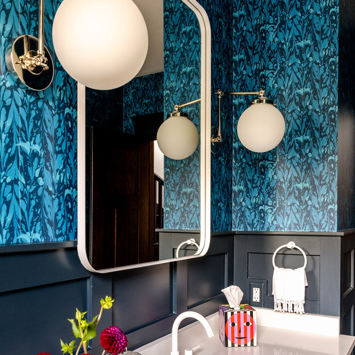 Ocean Seaweed wallpaper in Prussian Blue installed in a bathroom with dark blue wainscoting